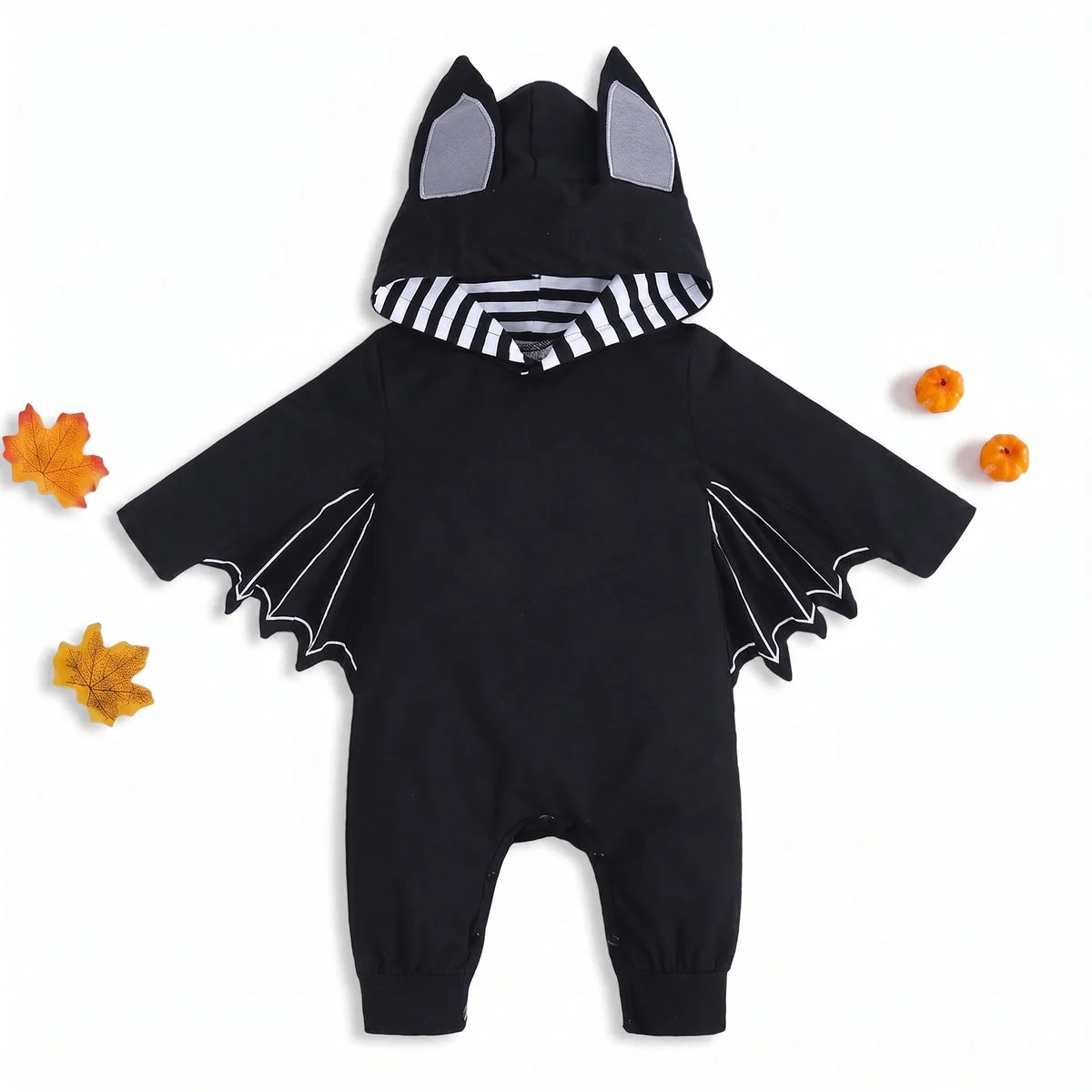 Black baby bat costume with striped hood and autumn leaves